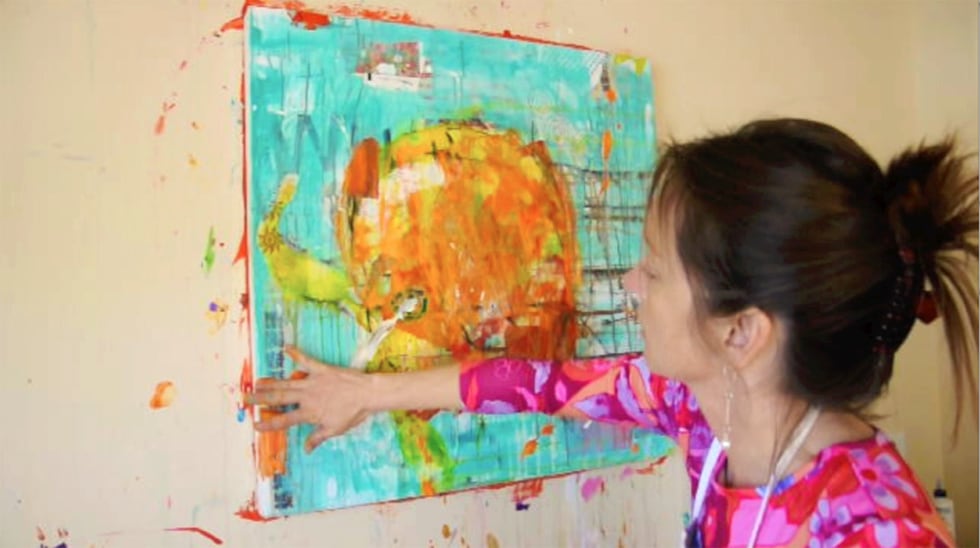 Kellie Day painting an orange